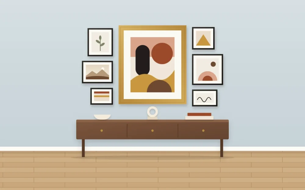 One large abstract artwork in a wide brass frame surrounded by six much smaller thin black frames above a walnut console